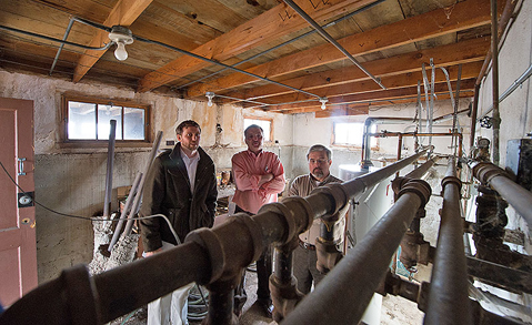 (left to right) NREL's Jesse Dean, Wally Piccone from the City of Lakewood, and NREL's Frank Rukavina assess the utility room: at the City of Lakewood's Graham House. NREL is coordinating a joint effort with the City of Lakewood and Red Rocks Community College to audit the Graham House and make suggestions for sustainable and energy-efficient modifications. The property was donated to the City and is used for public meetings and events. Photograph courtesy of NREL by Dennis Schroeder